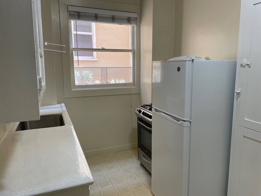 a kitchen with a refrigerator and a window